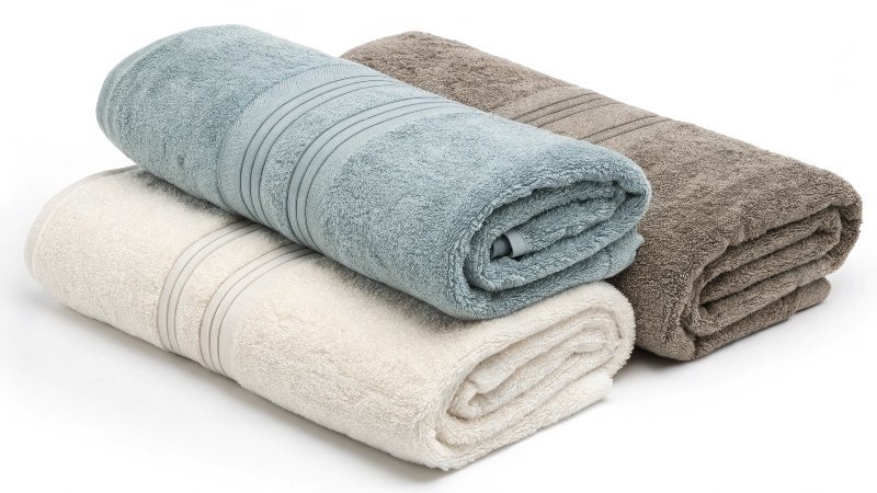 A person wrapping themselves in a luxurious white cotton towel